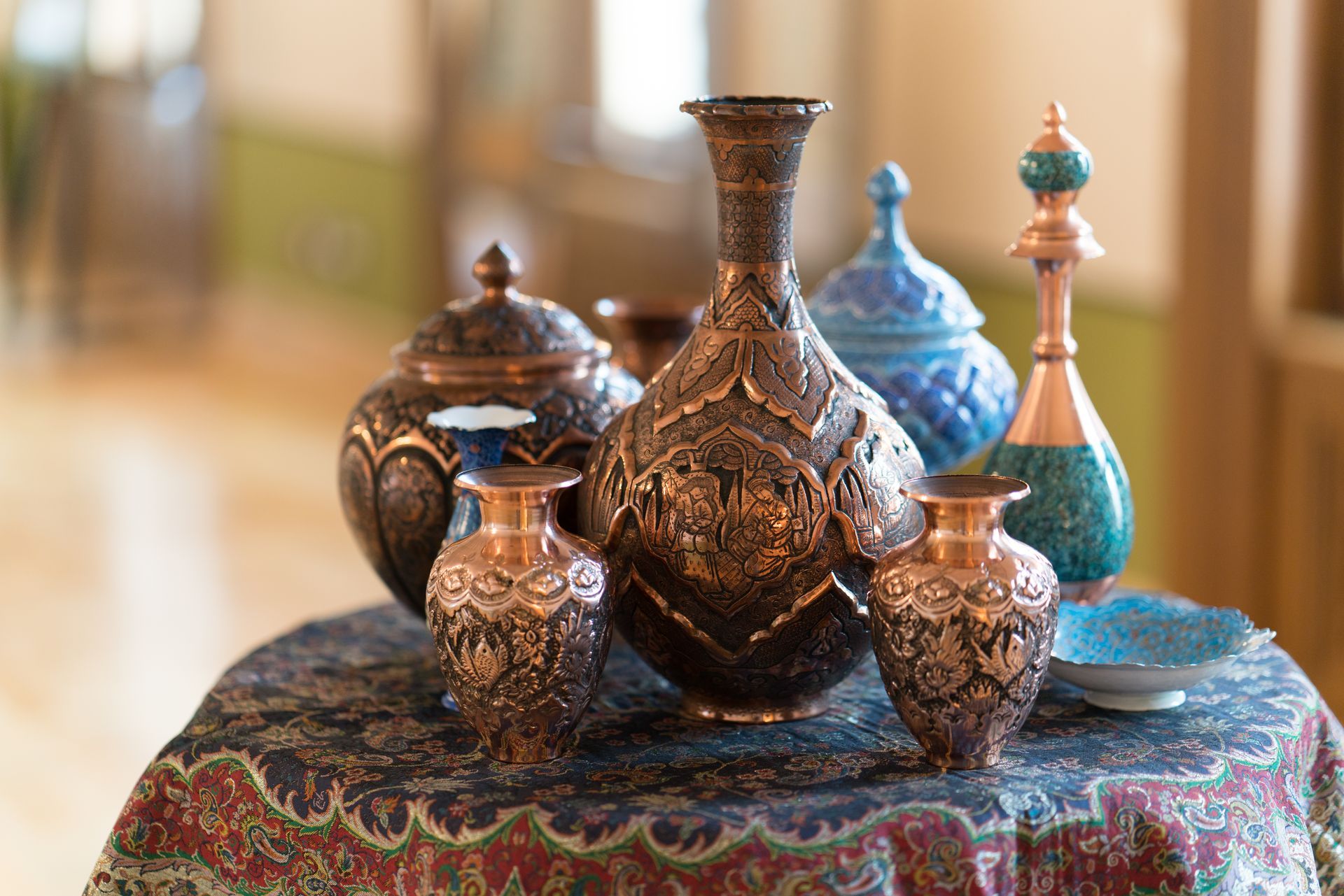 A group of vases sitting on top of a table.