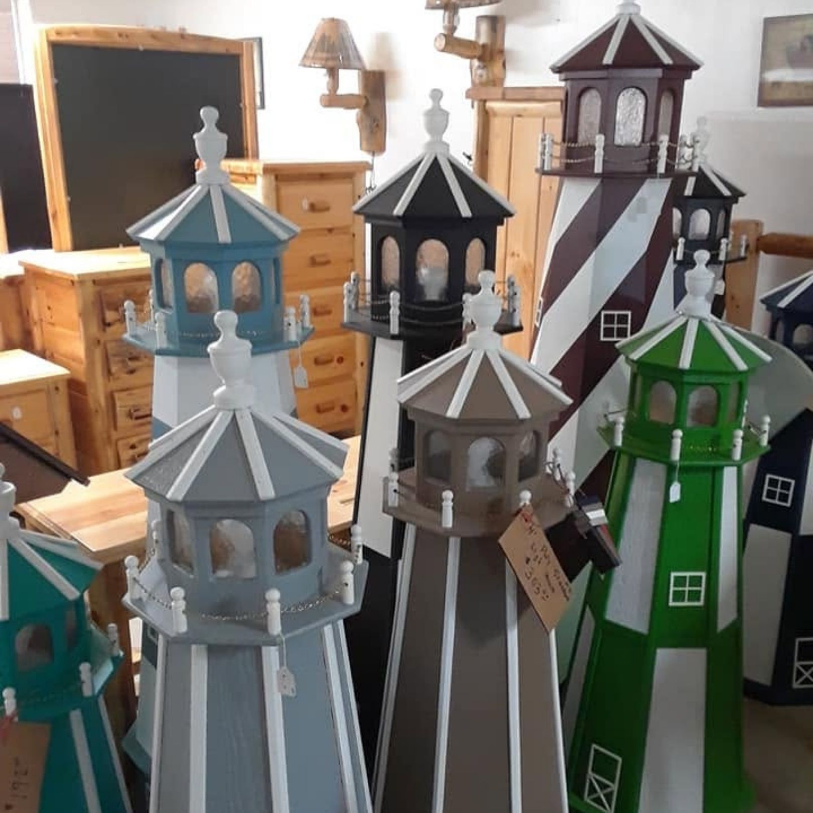 Assorted decorative lantern towers in blue, gray, black, green, and red, displayed in a room