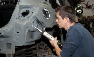 mechanic working on car body