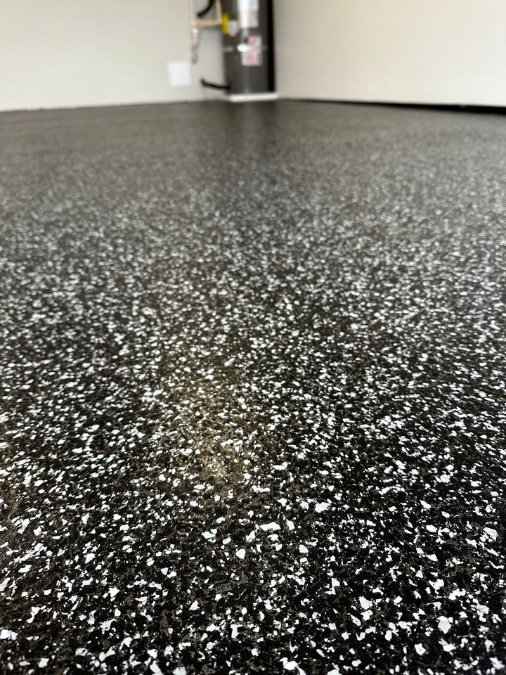 A close up of a black and white floor in a garage