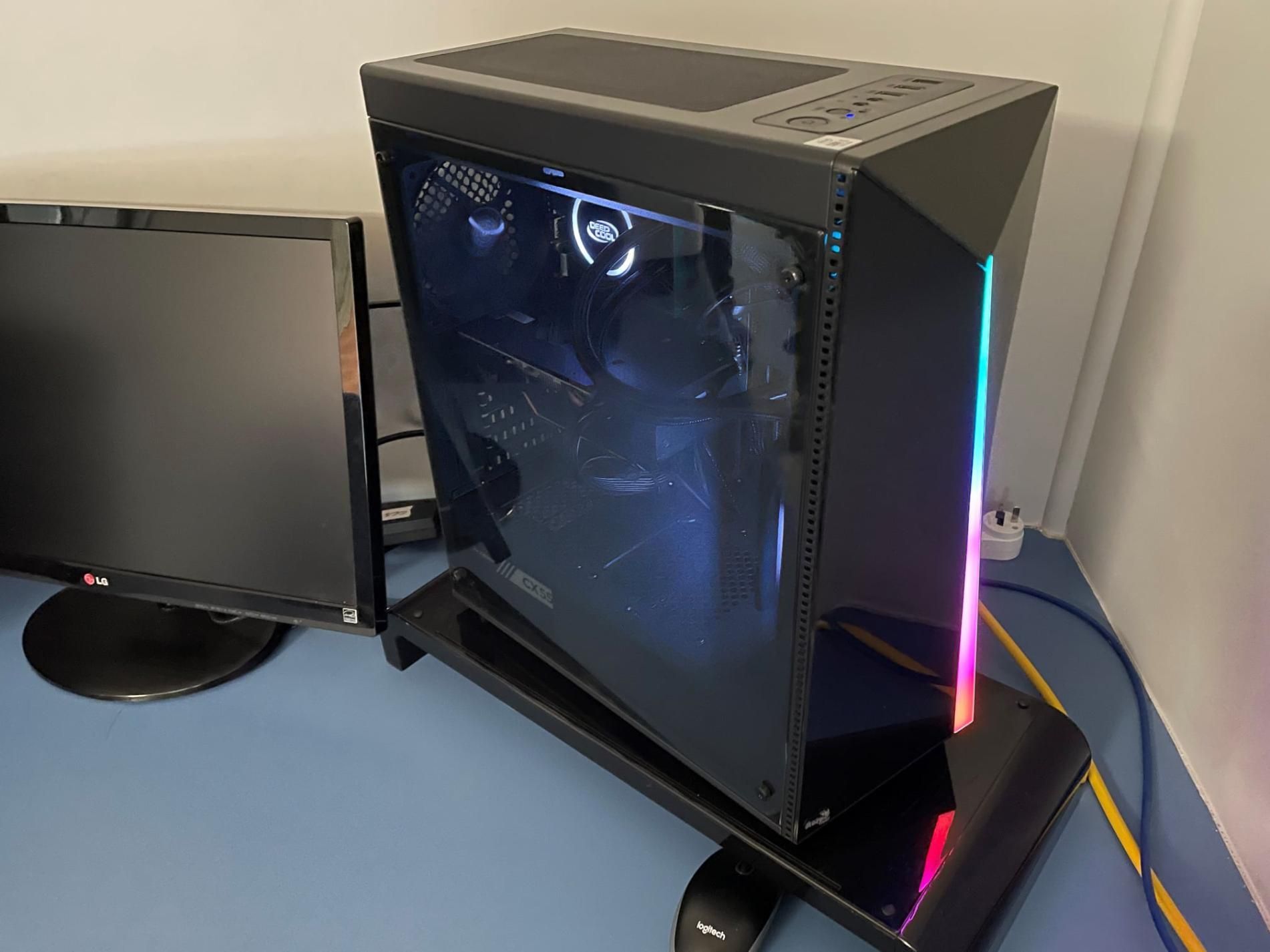 A Computer is Sitting on a Table Next to a Monitor — Coastal Computing Solutions in Forster, NSW