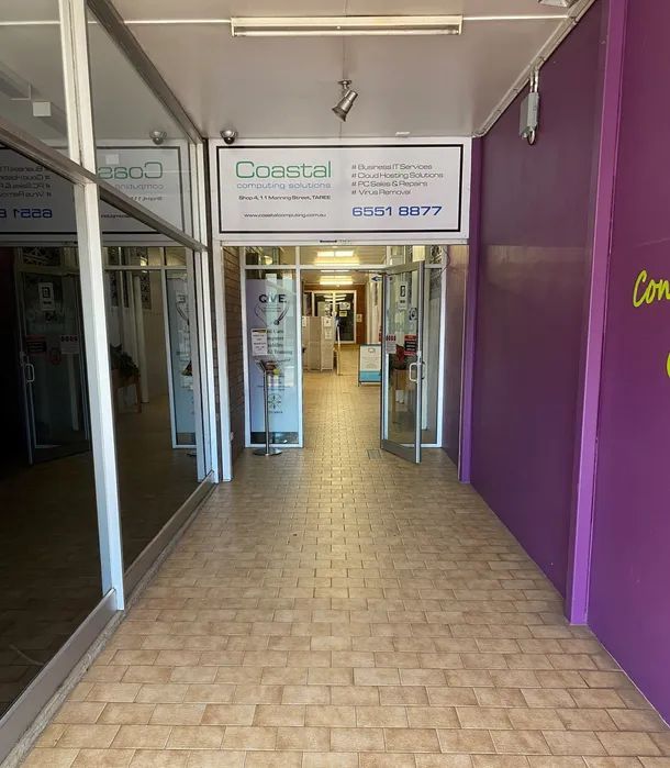 A Hallway With Purple Walls and a Sign That Says Comfort — Coastal Computing Solutions in Taree, NSW