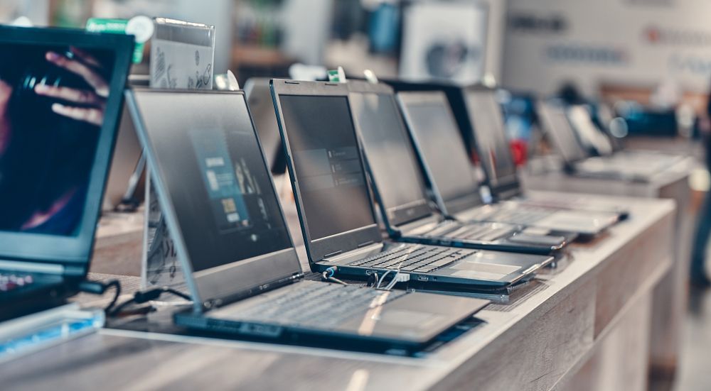 A Row of Laptops Are Sitting on a Table in a Store — Coastal Computing Solutions in Taree, NSW