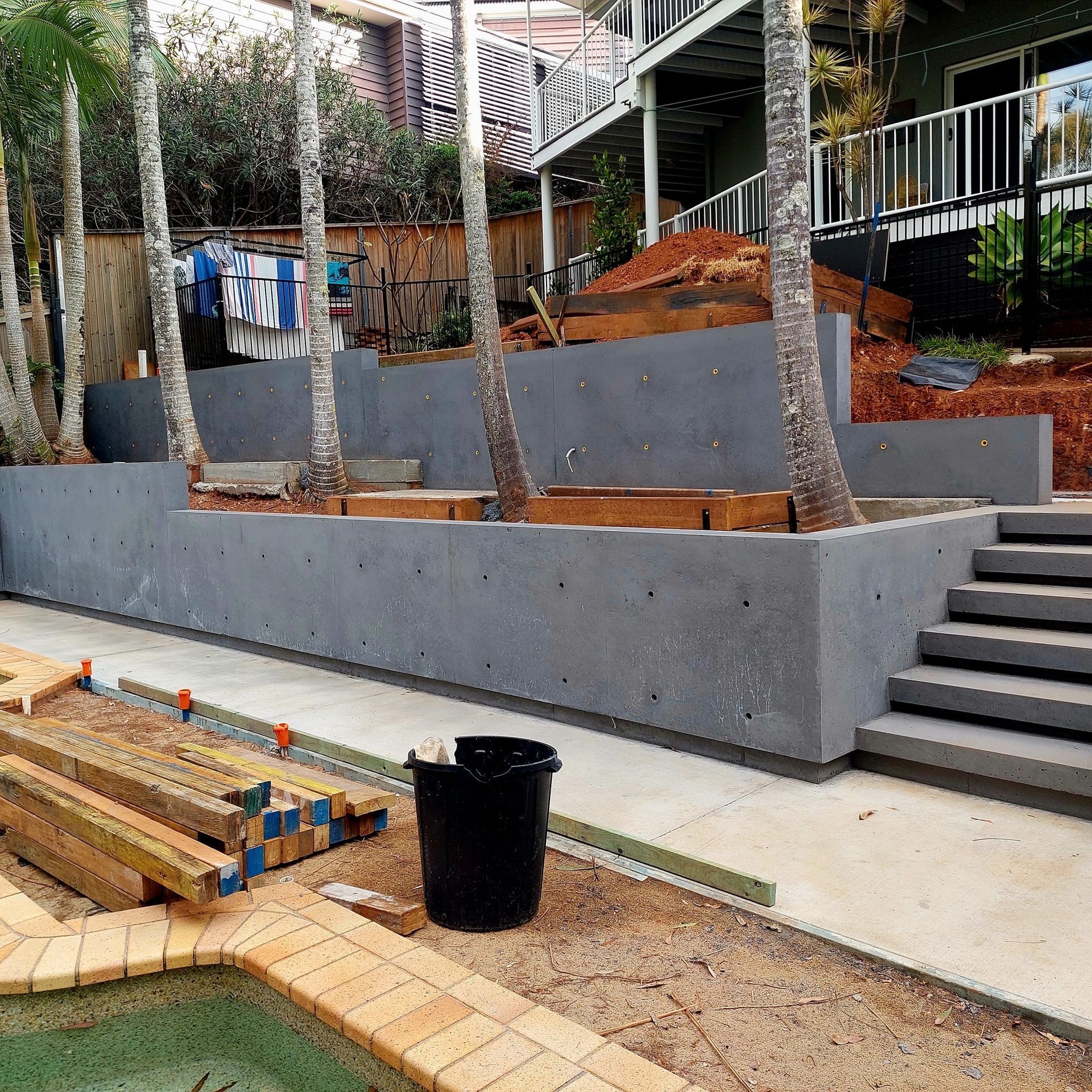 Concrete Wall with Stairs Leading up To It — Green Envy Landscapes Pty Ltd In Carrara, QLD