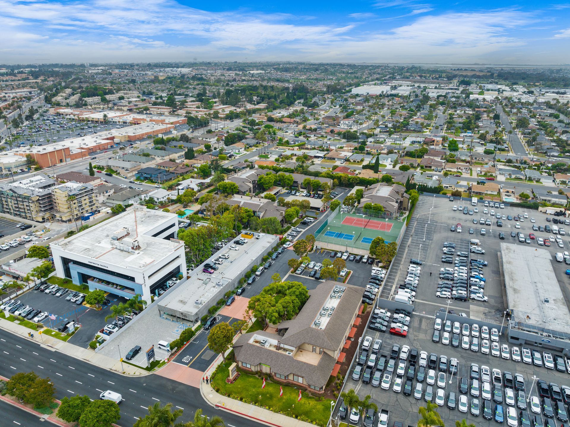 overhead view of buildings, streets, and parking lot