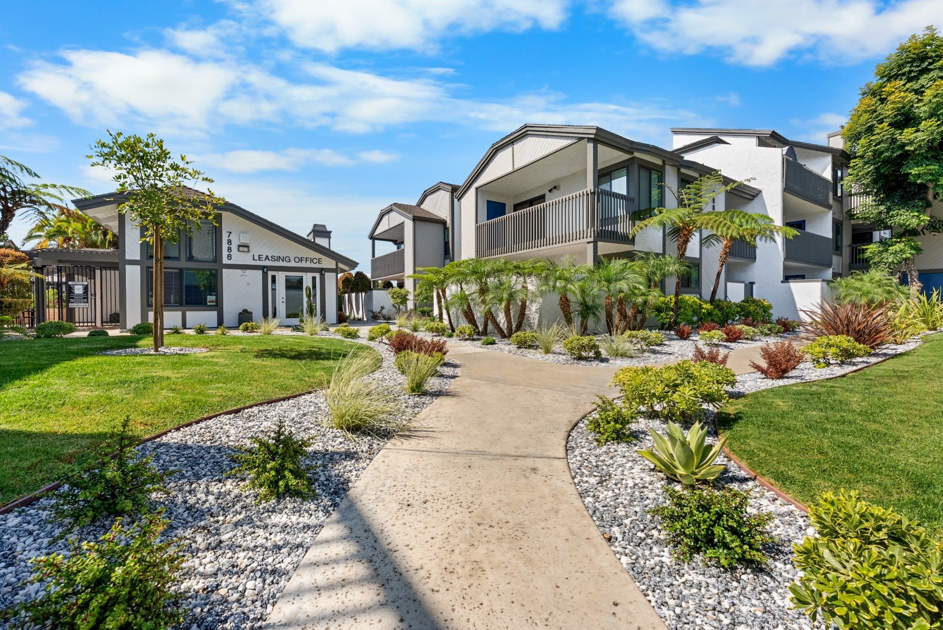 Exterior leasing office and walkway with landscaping