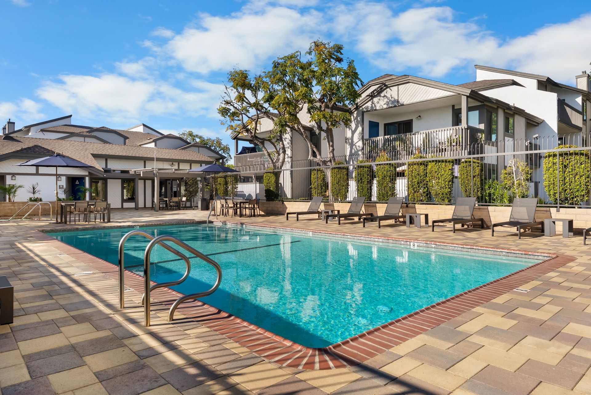 straight down shot of swimming pool and lounge chairs