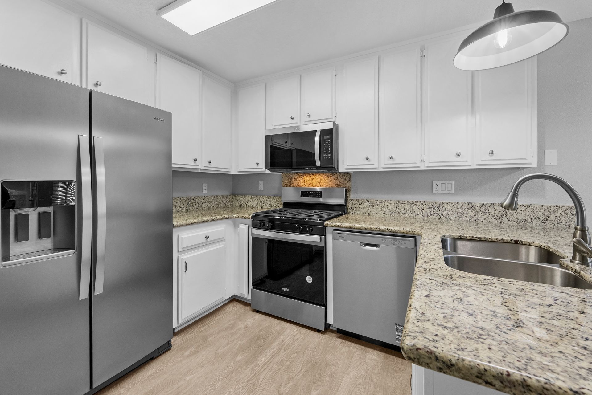 kitchen with stove, microwave, refrigerator, and oven