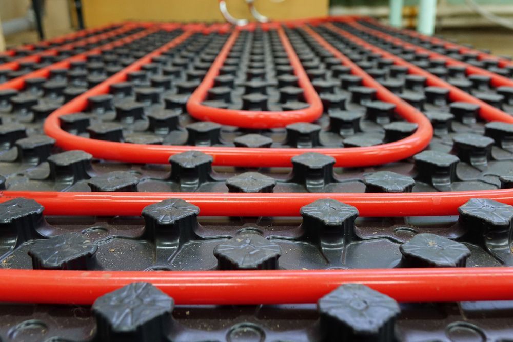 A Hydronic Heating System Featuring Red and Black Pipes — Illawarra Underfloor Heating In Bellambi, NSW