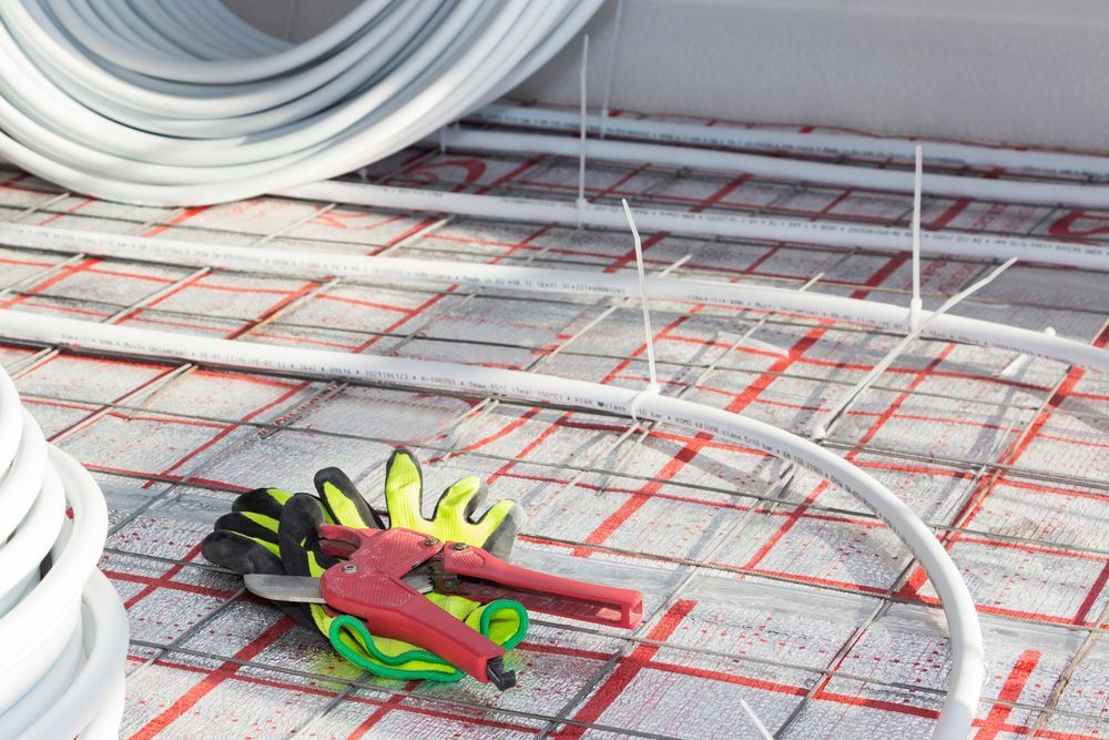White Tubing and Red Grid on Flooring — Illawarra Underfloor Heating In Bellambi, NSW