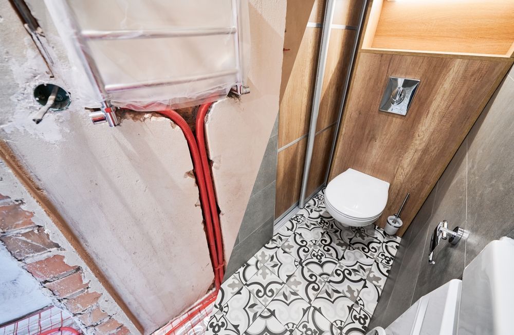 Renovated bathroom: before (left) showing plumbing, after (right) with patterned tile, toilet, and wood paneling. — Illawarra Underfloor Heating In Southern Highlands, NSW