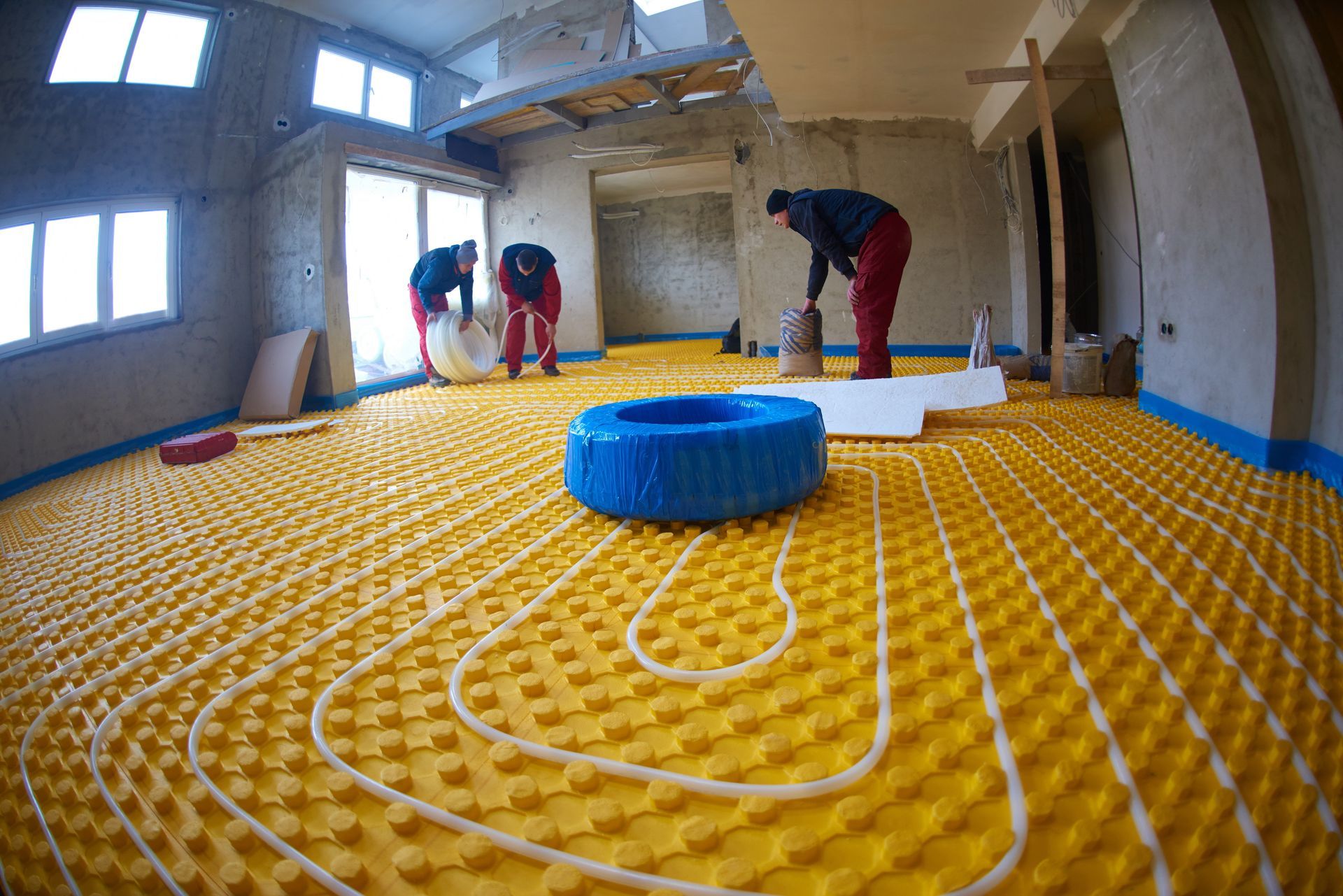 Workers Installing Underfloor Heating — Illawarra Underfloor Heating In Shellharbour, NSW