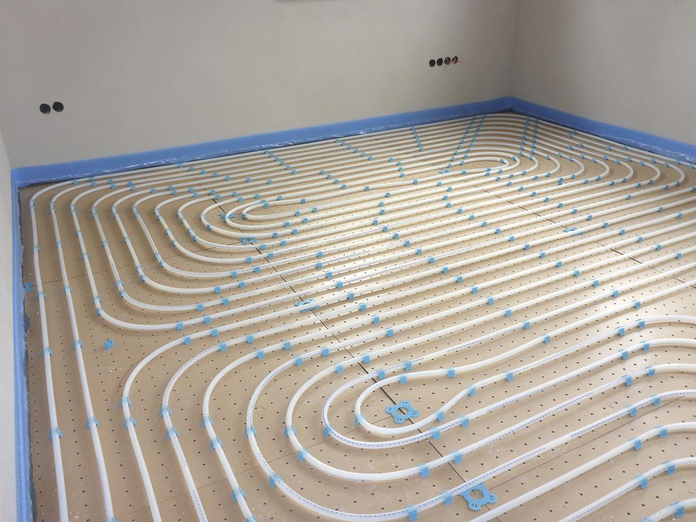 White Tubes Laid Across a Floor — Illawarra Underfloor Heating In Shellharbour, NSW