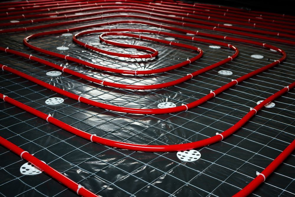 Red Radiant Floor Heating Tubes Snaking Across a Black Grid — Illawarra Underfloor Heating In Shellharbour, NSW