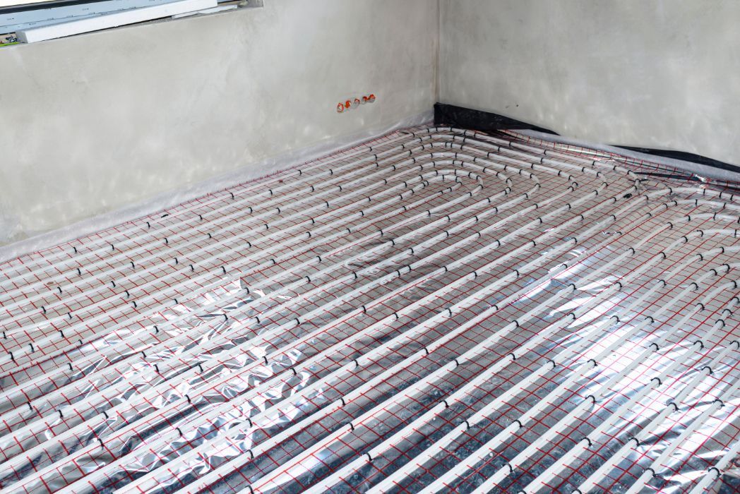 Floor with Embedded Red Tubing for Radiant Heating — Illawarra Underfloor Heating In Kiama, NSW