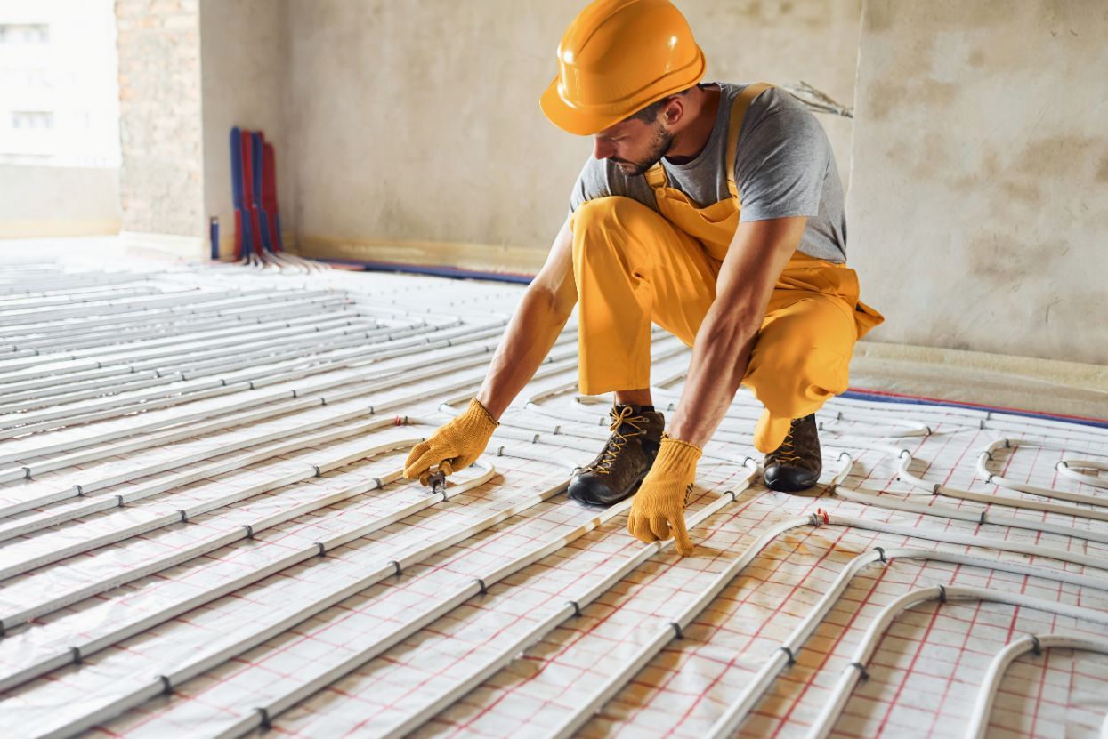 Construction Worker Installing Radiant Floor Heating Tubes — Illawarra Underfloor Heating In Nowra, NSW