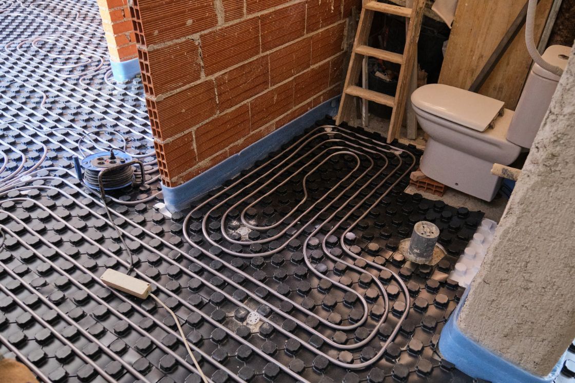 Underfloor Heating Installation with Black Plastic Matting — Illawarra Underfloor Heating In Nowra, NSW