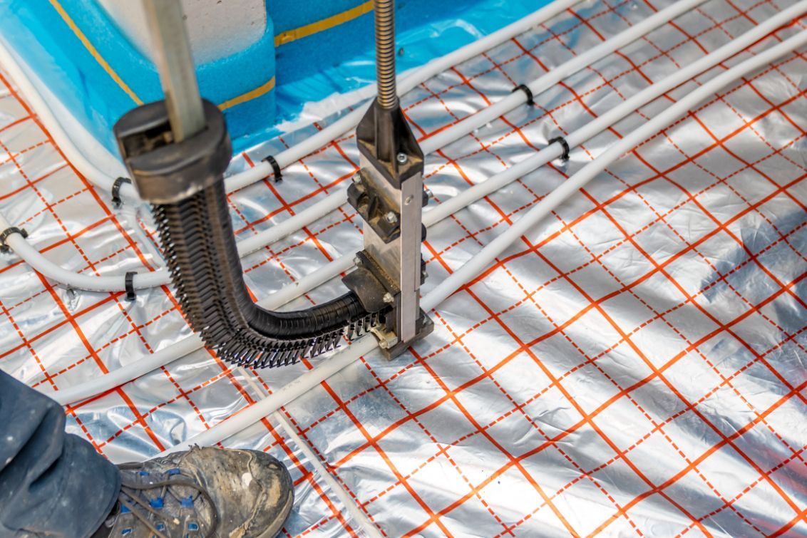 Installing Underfloor Heating Pipes with A Specialized Tool — Illawarra Underfloor Heating In Ulladulla, NSW