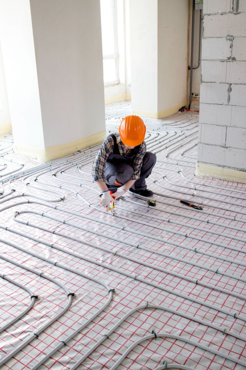 Worker Installing Radiant Floor Heating System — Illawarra Underfloor Heating In Southern Highlands, NSW