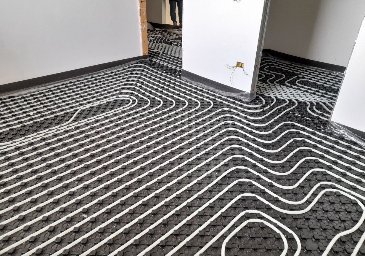 White Tubing Installed on Black Insulation for Radiant Floor Heating — Illawarra Underfloor Heating In Nowra, NSW