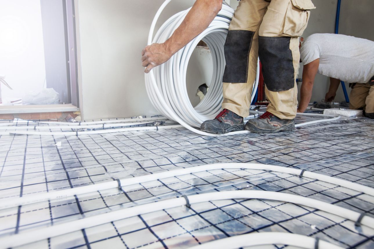 Construction Worker Installing Radiant Floor Heating Tubes — Illawarra Underfloor Heating In Nowra, NSW