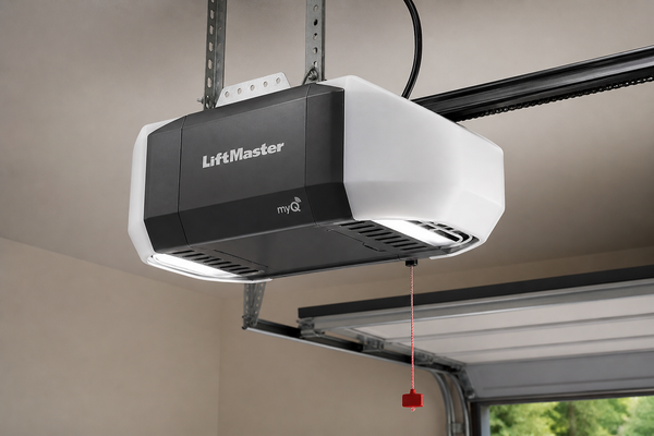 Ceiling-mounted white and black garage door opener above an open garage door