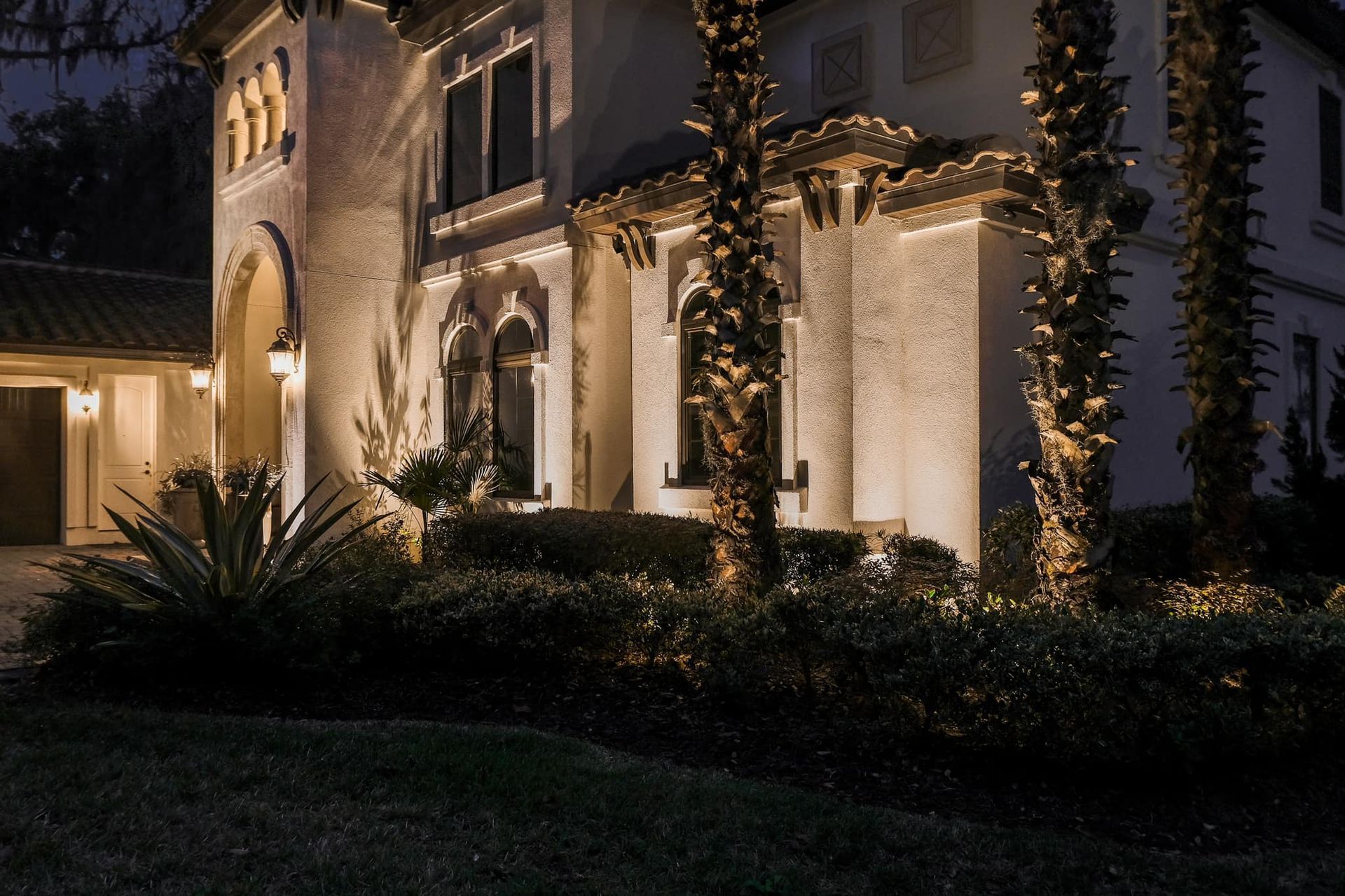 The front of a house is lit up at night