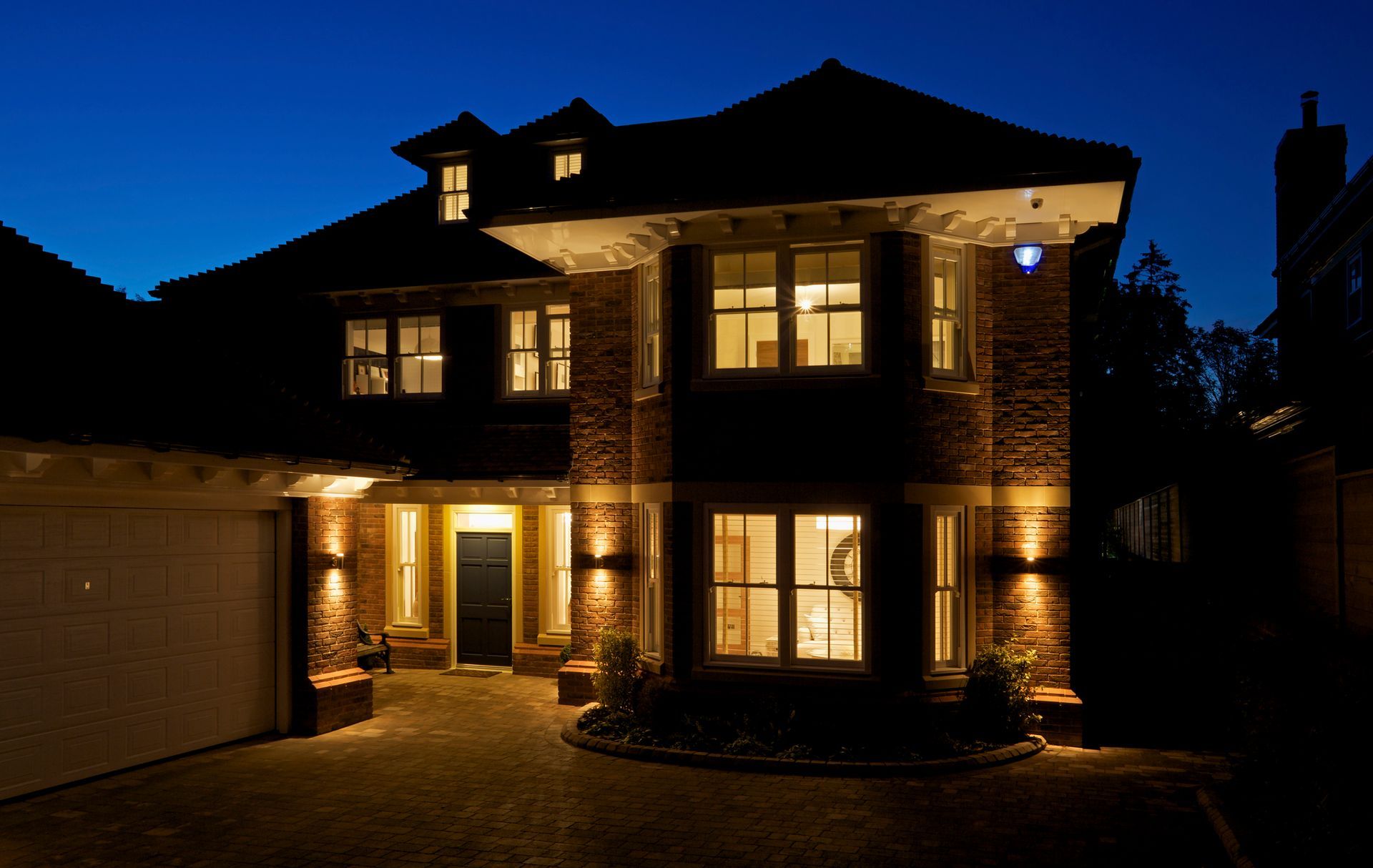 New home at dusk with all interior and exterior lights on. | Roof Line Lighting | Jacksonville, FL 