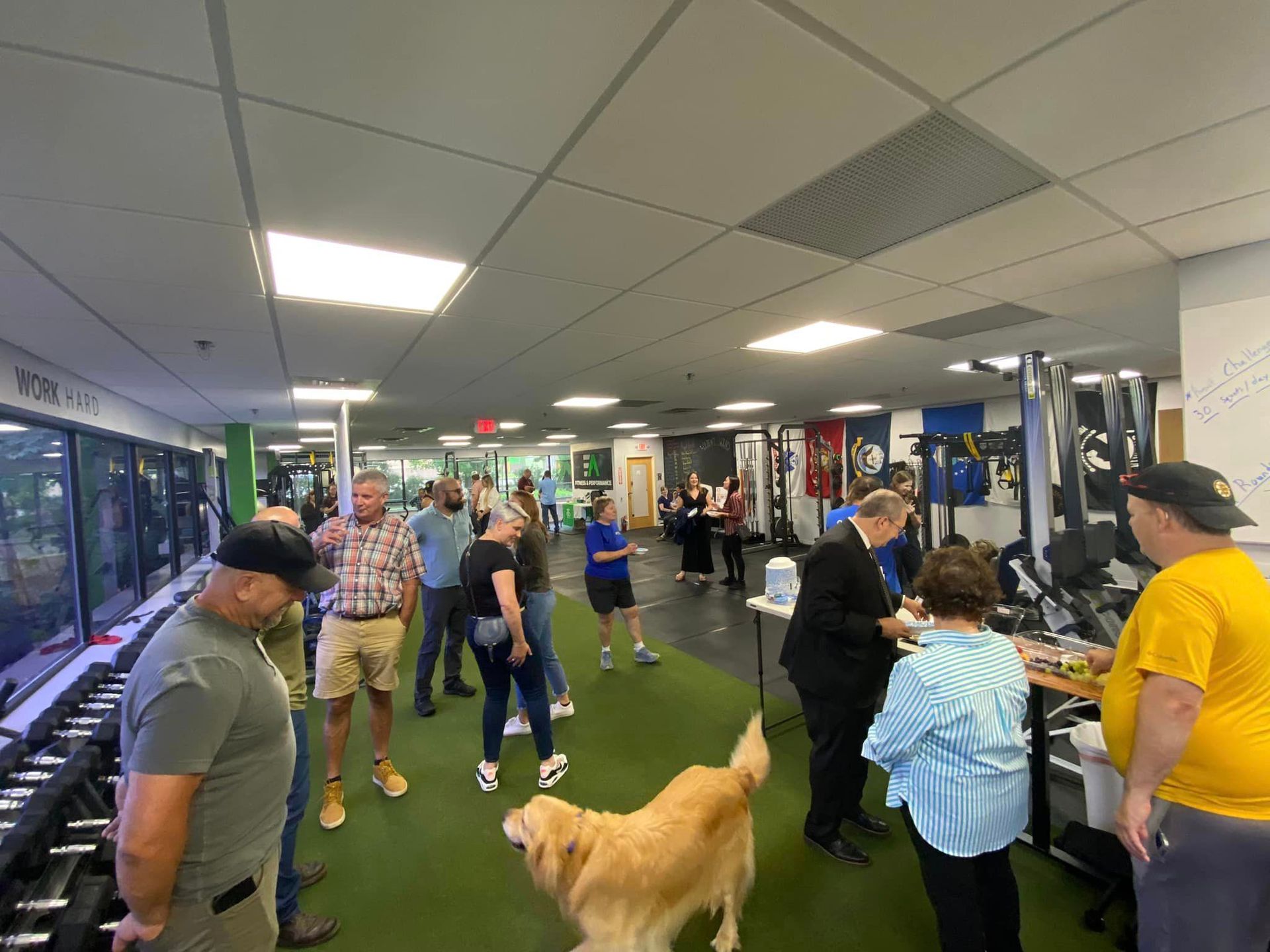 A woman is doing a pull up on a bar in a gym.