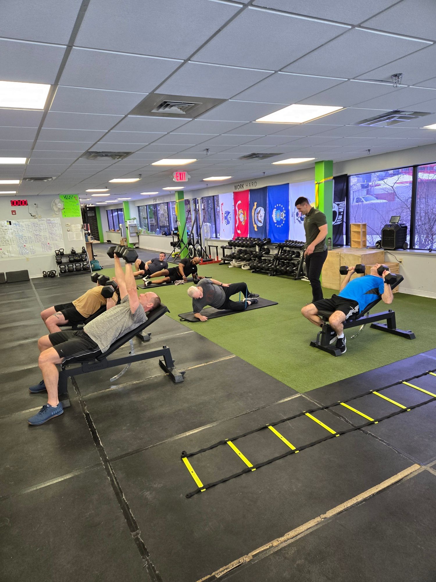A group of women are standing in a gym.