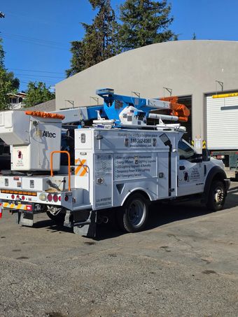 Gray electrical panel with yellow safety barrier in a room.