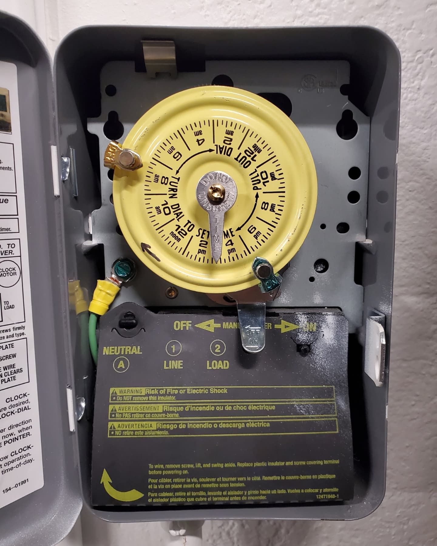 Open gray electrical box with a yellow timer dial and wiring visible.