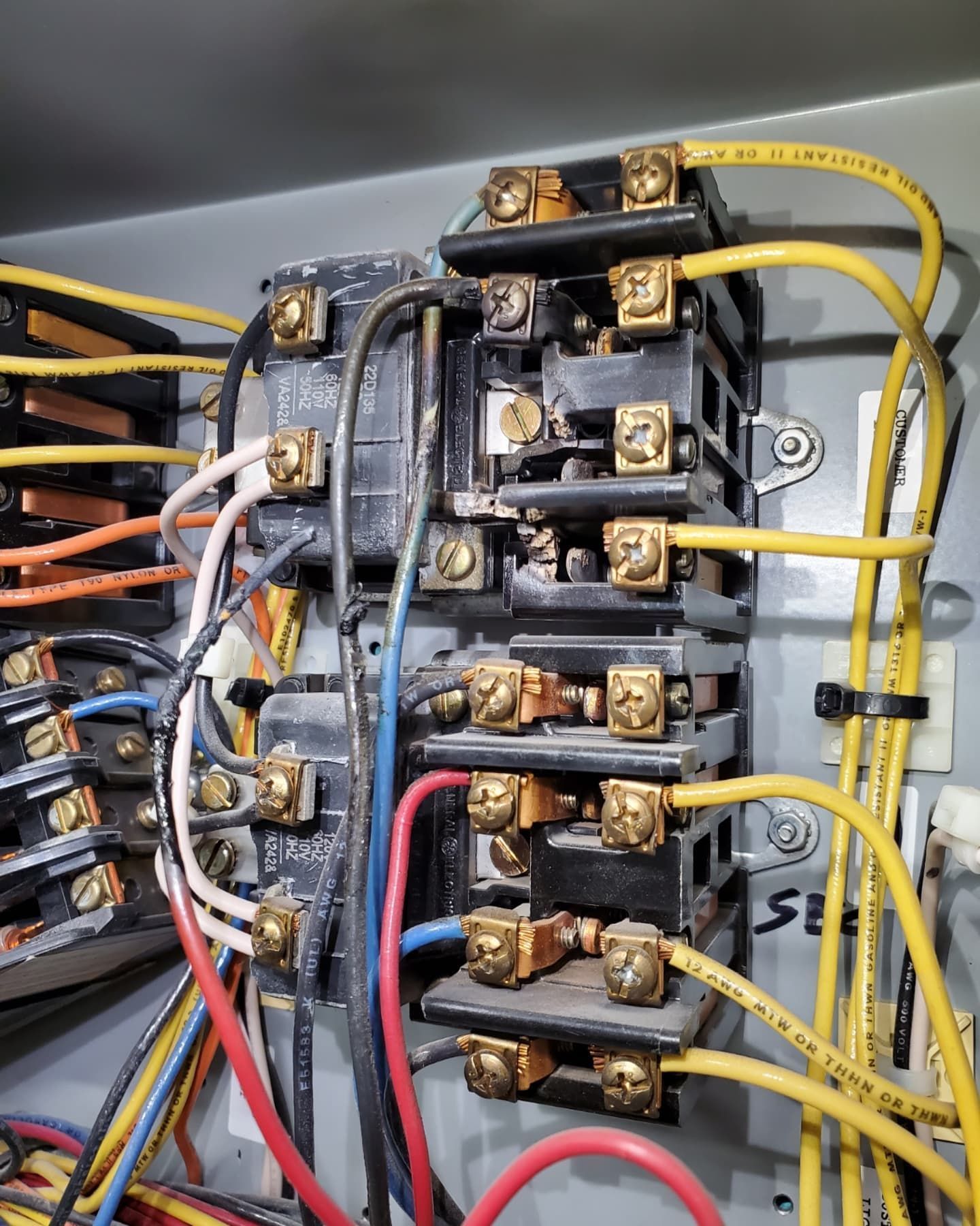 Electrical control box with wires and terminals.
