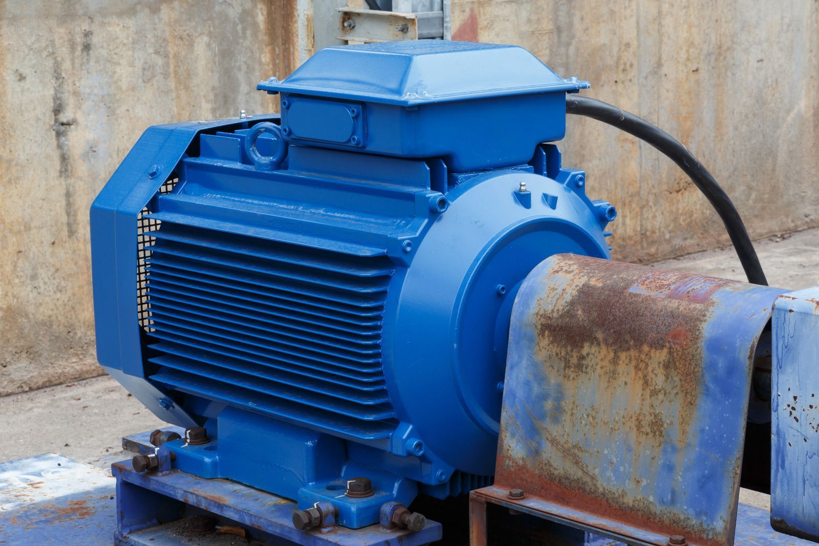 Electrician testing wires in electrical panel with a multimeter.