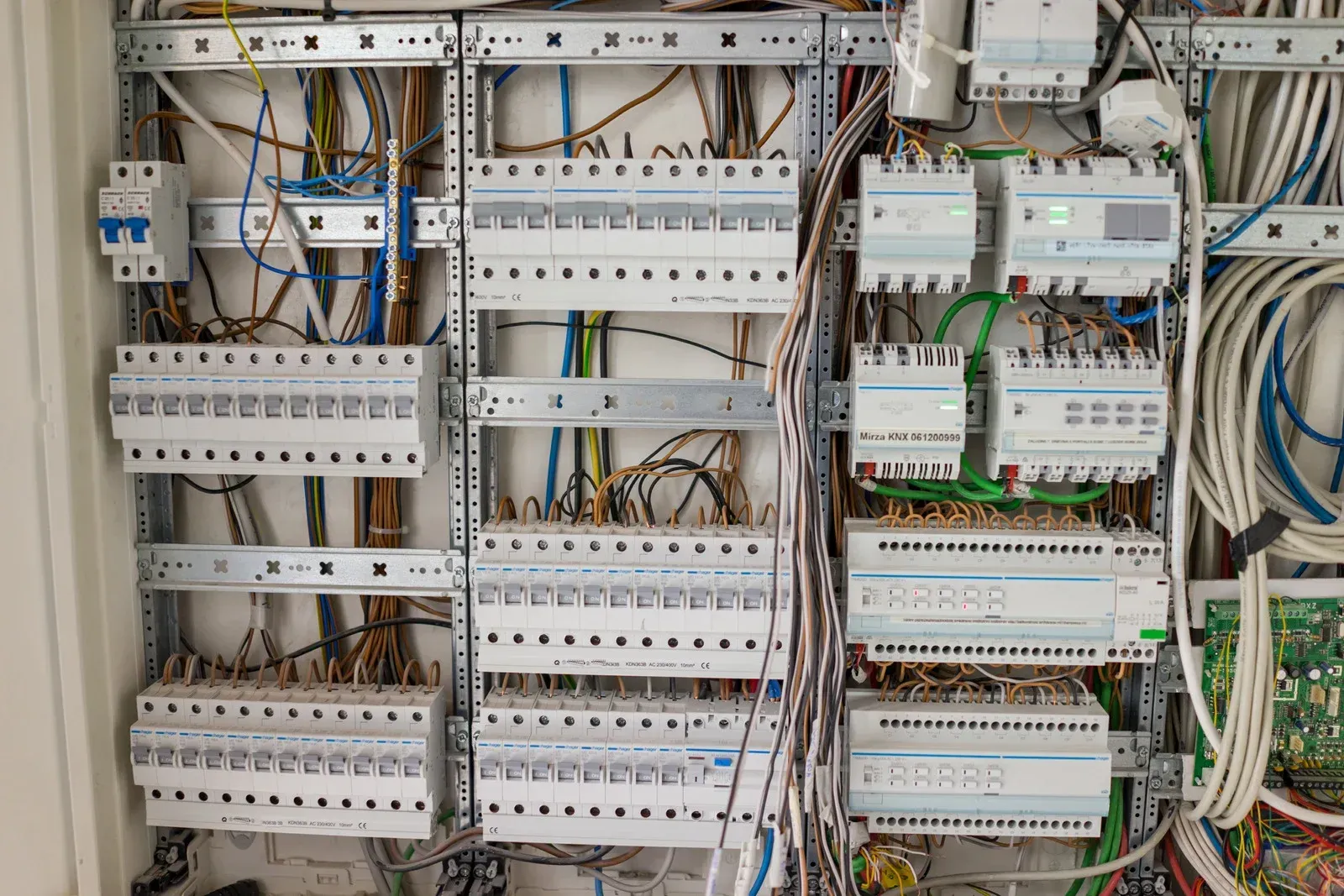 Electrical panel with numerous circuit breakers and wiring.
