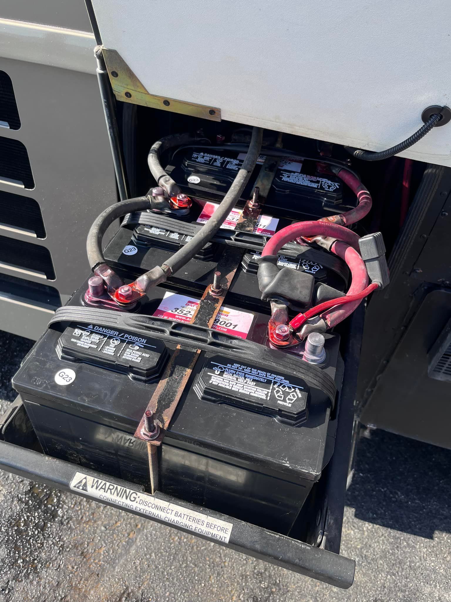 A man is installing an air conditioner on the side of a building.