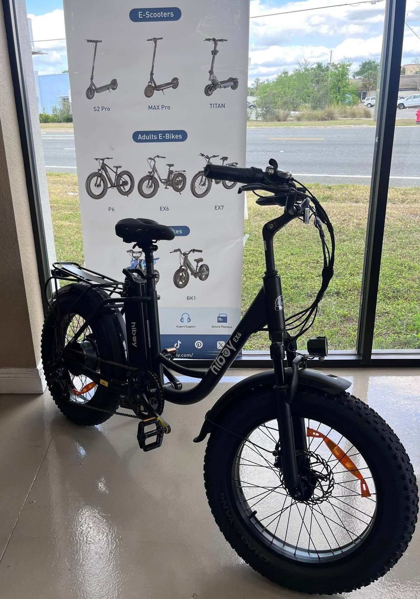 A man is installing an air conditioner on the side of a building.