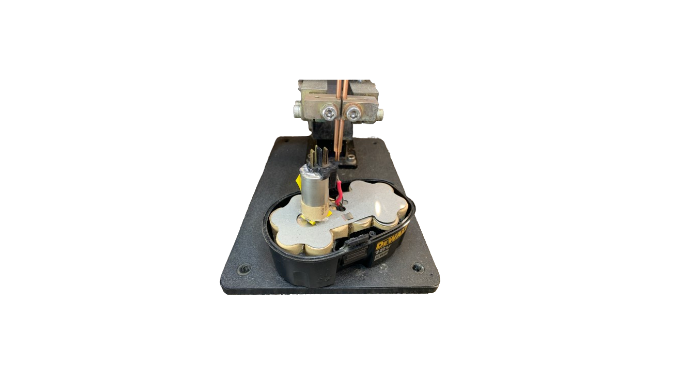 Mechanical device with gears and a vertical component on a black base.