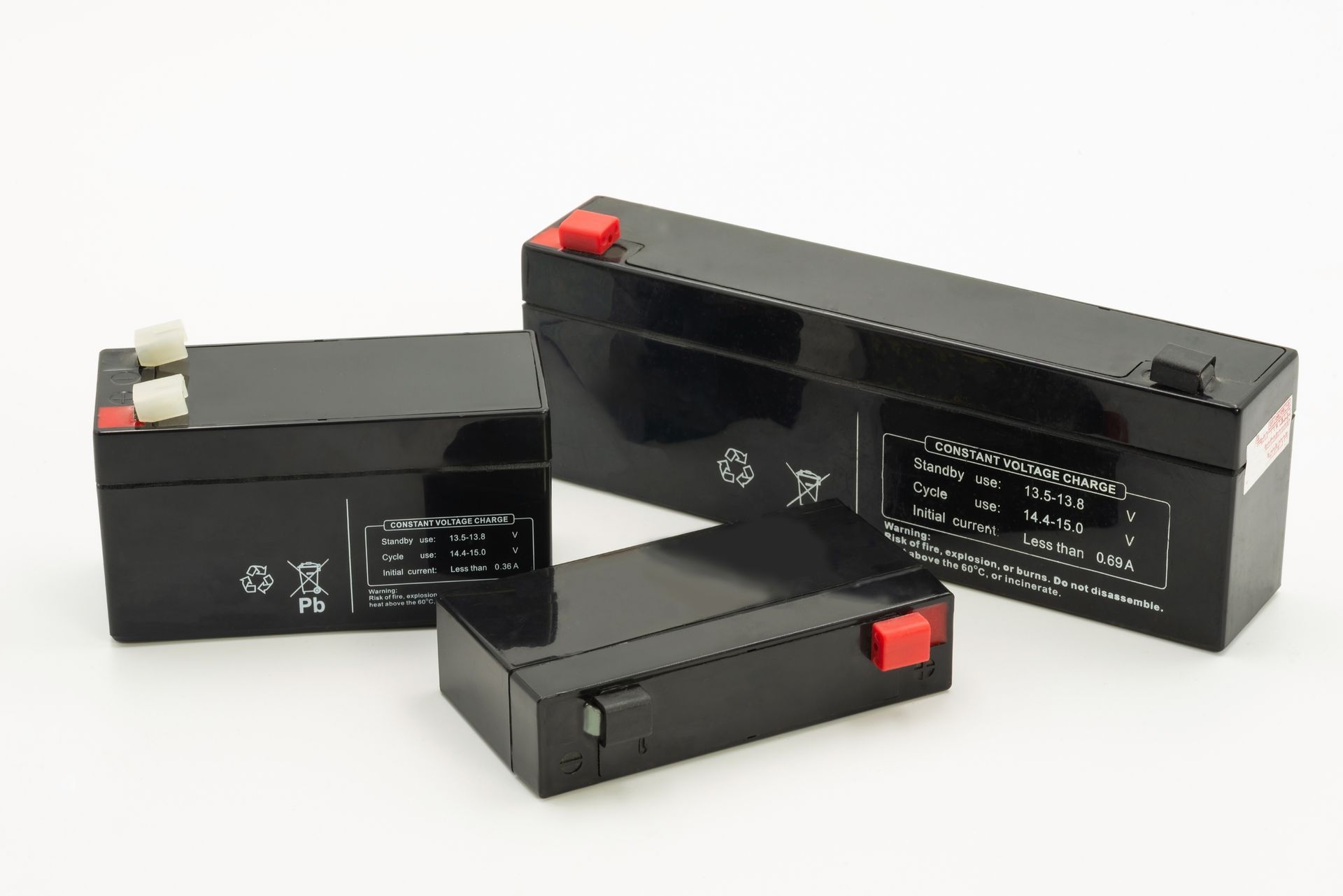 Three black rectangular batteries with red and white terminals on a white background.