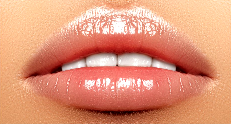 a close up of a woman's lips with white teeth .