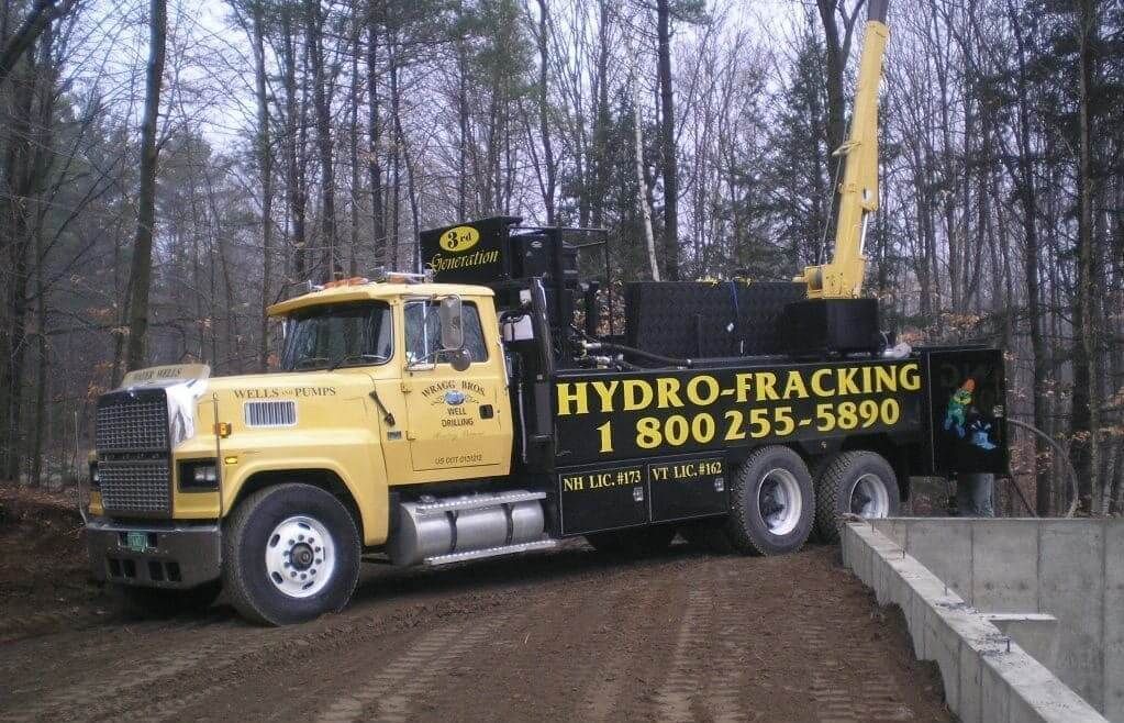 A yellow well drilling truck that says hydro-fracking on the side