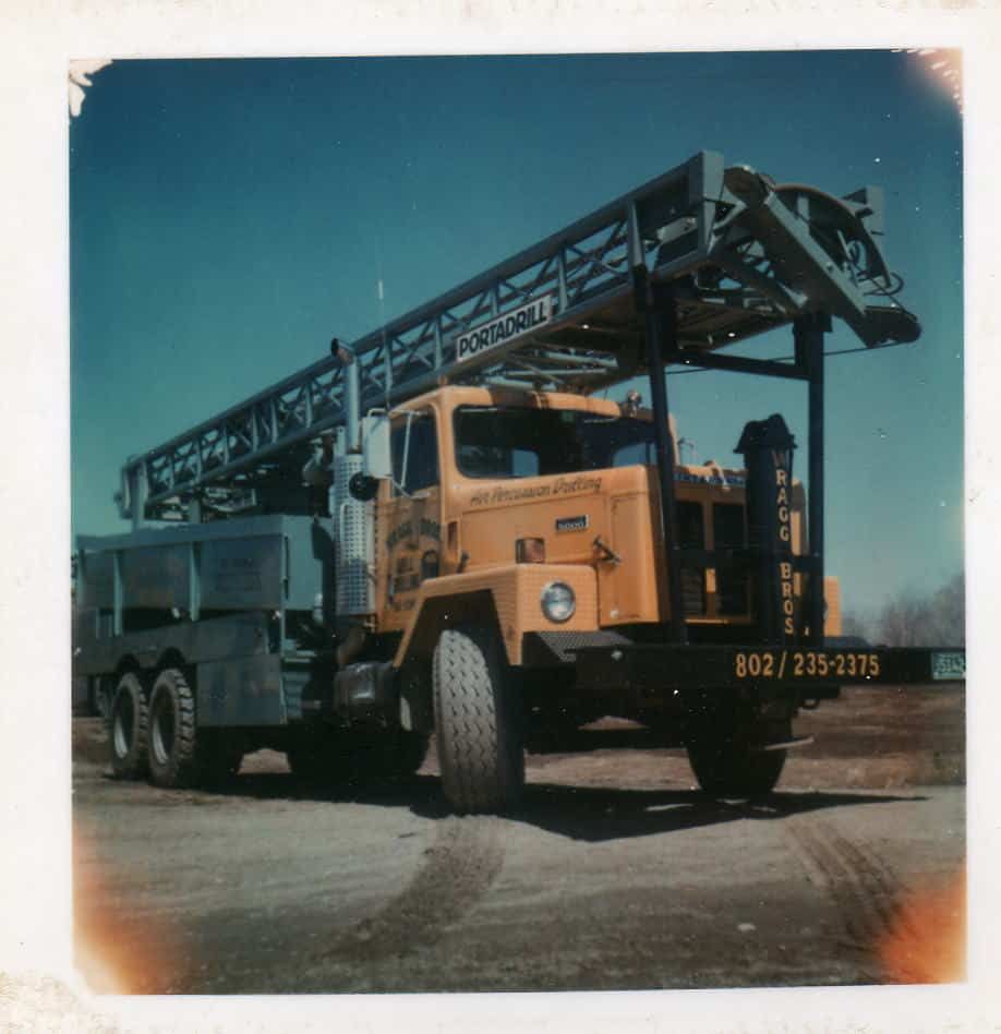 A yellow drilling truck from Wragg Brothers Well Drilling