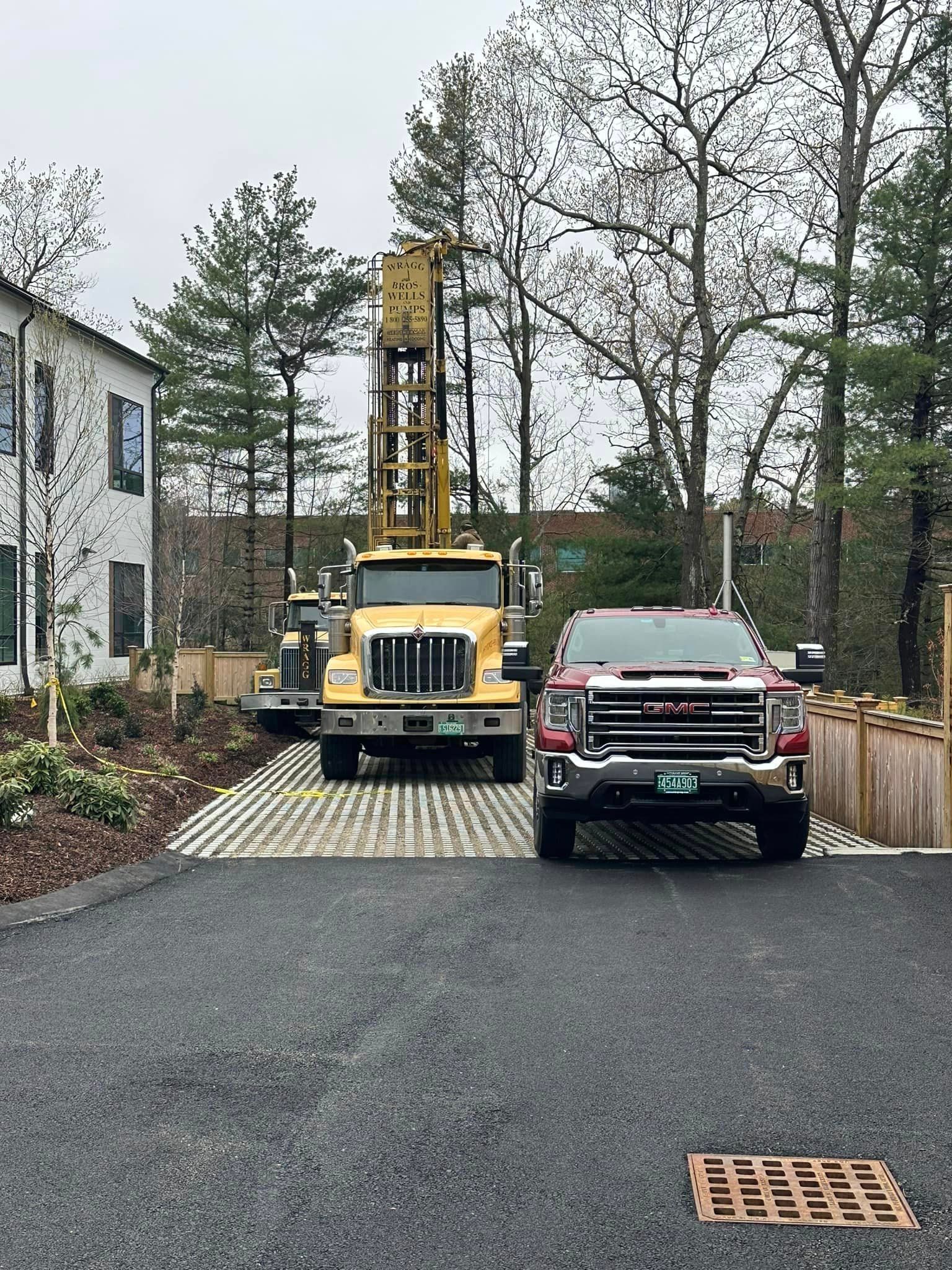 A yellow truck is parked in front of a house.