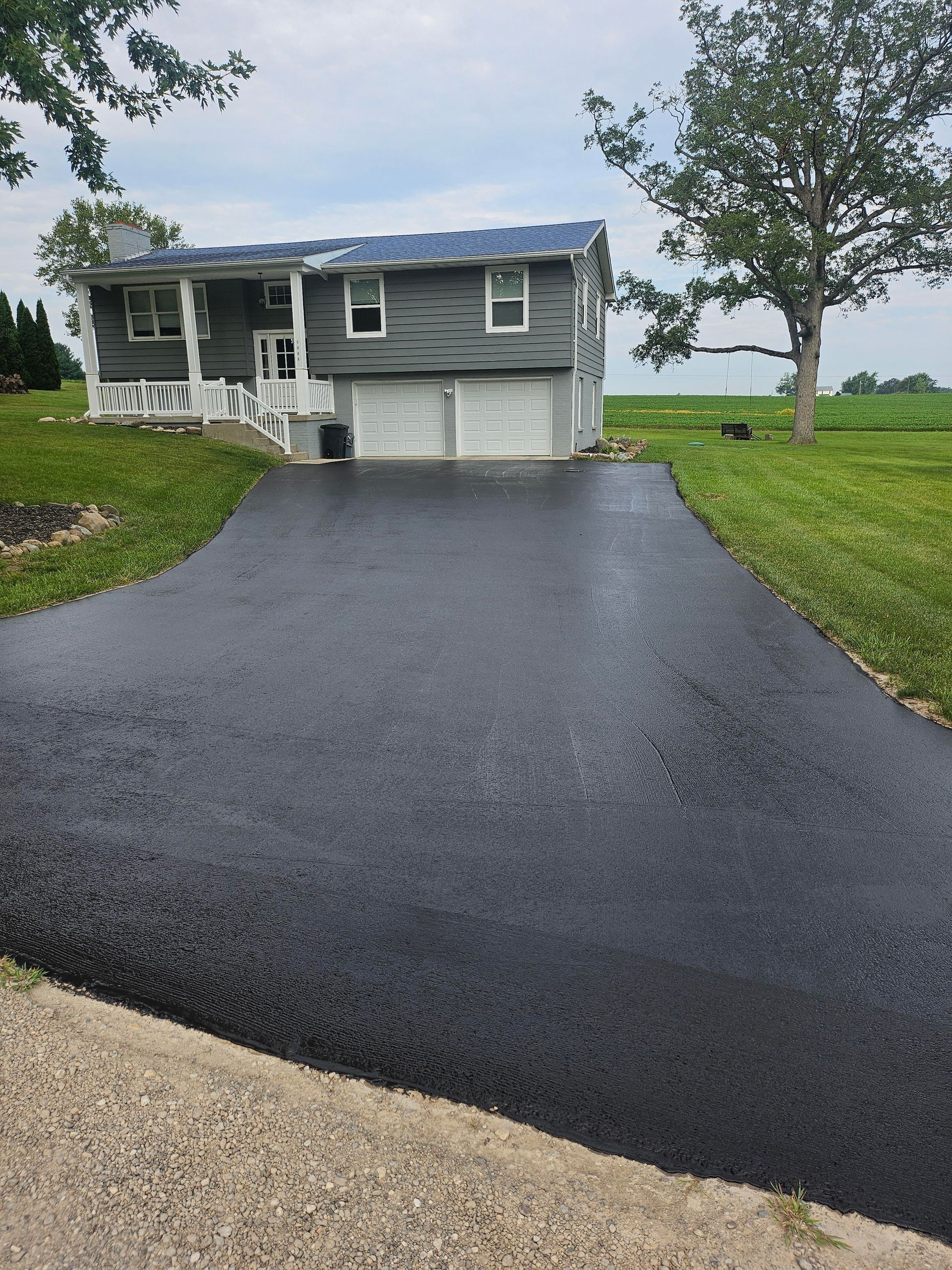 A house with a large driveway leading to it
