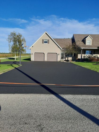 A large house with a large driveway in front of it.