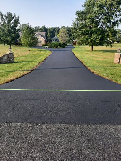 A driveway leading to a house in a residential area.
