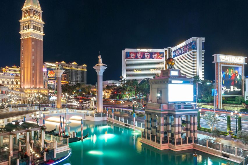 Venetian Hotel, Las Vegas, at night. Buildings with bright lights reflected in a canal.
