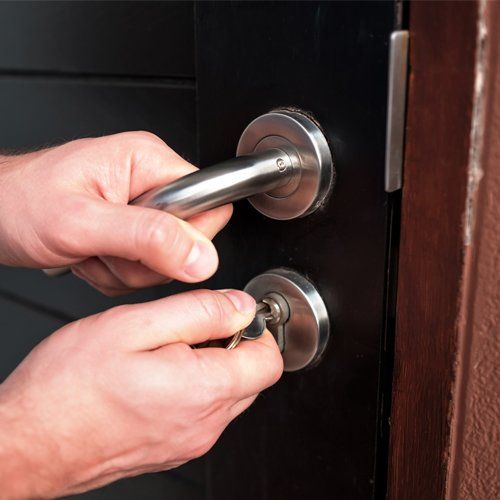 Man Hand Opening Black Door — San Rafael, California — Transbay Security Services Inc.