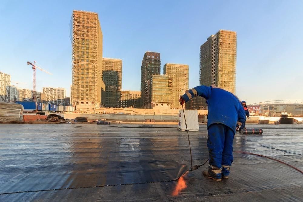 A man is repairing a roof.