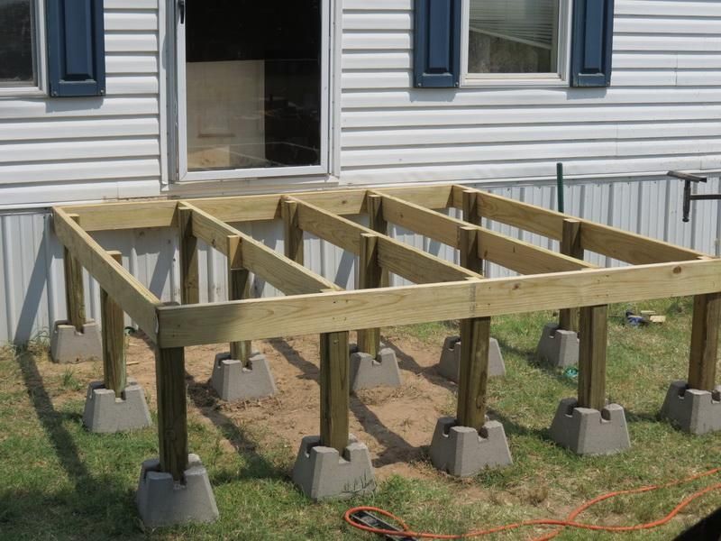 An image showing a deck under construction with partially completed deck frames.